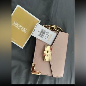 Michael kors wallet never used! Pink and has card holders
